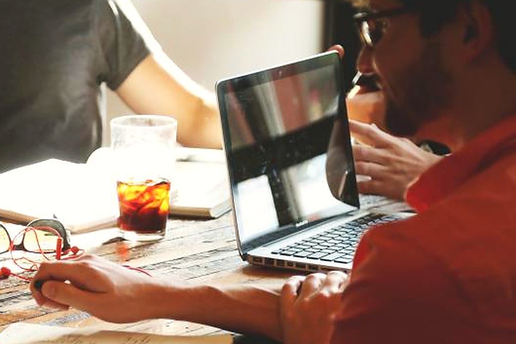 A business owner at a table with a laptop during a working session
